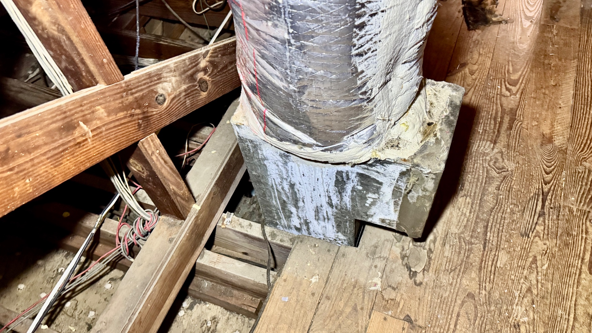 Wet metal duct boot at a framing penetration.